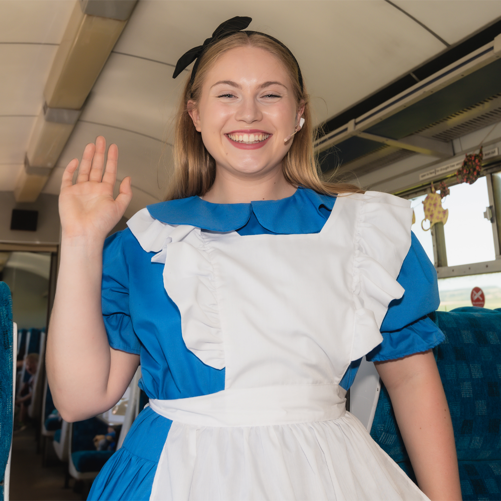 Alice on board The Mad Hatter's Travelling Tea Party Train